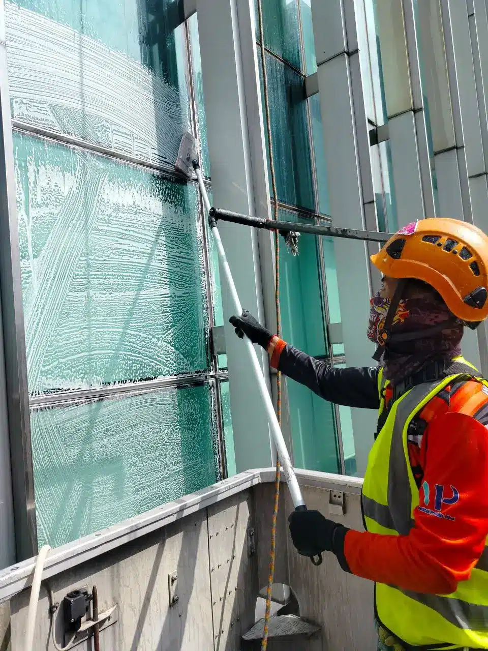external window cleaning contractor Malaysia technician cleaning high-rise glass