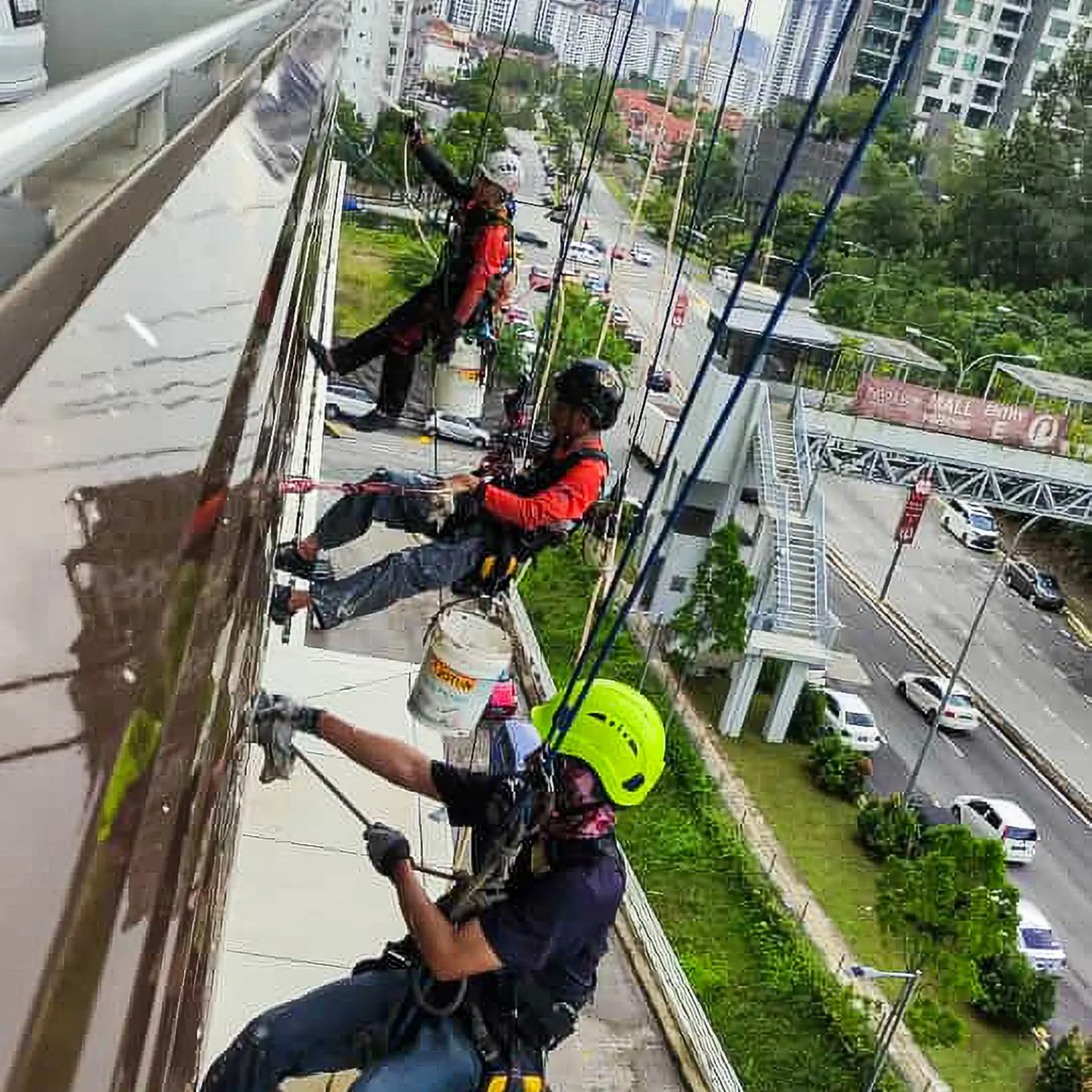 rope access facade cleaning technicians working on a high-rise elevation in Malaysia
