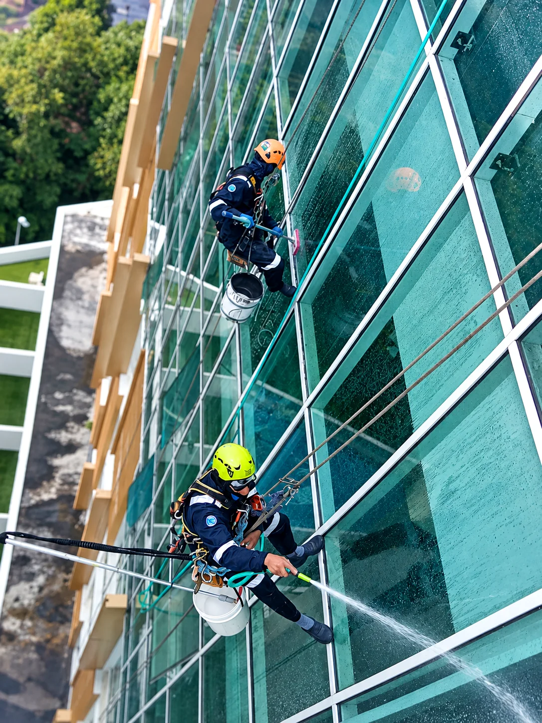 Vertical Pro rope access technicians cleaning a high-rise facade in Malaysia