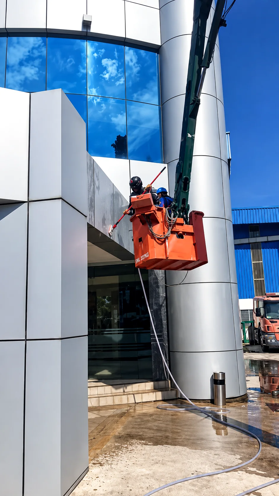 Professional technicians carrying out external facade cleaning