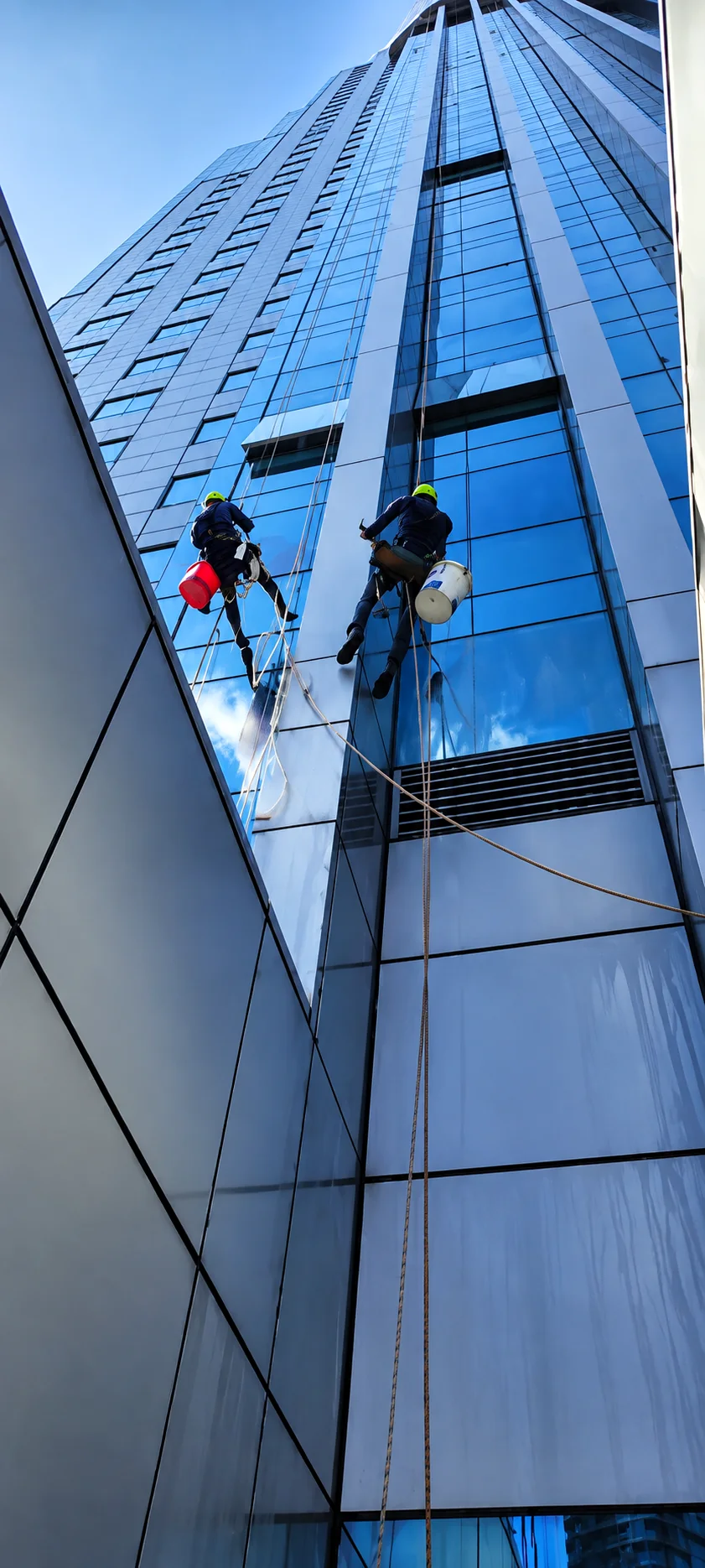 Vertical Pro rope access technicians descending on a high-rise facade