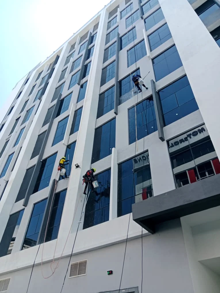 Rope access technician carrying out high-rise exterior work