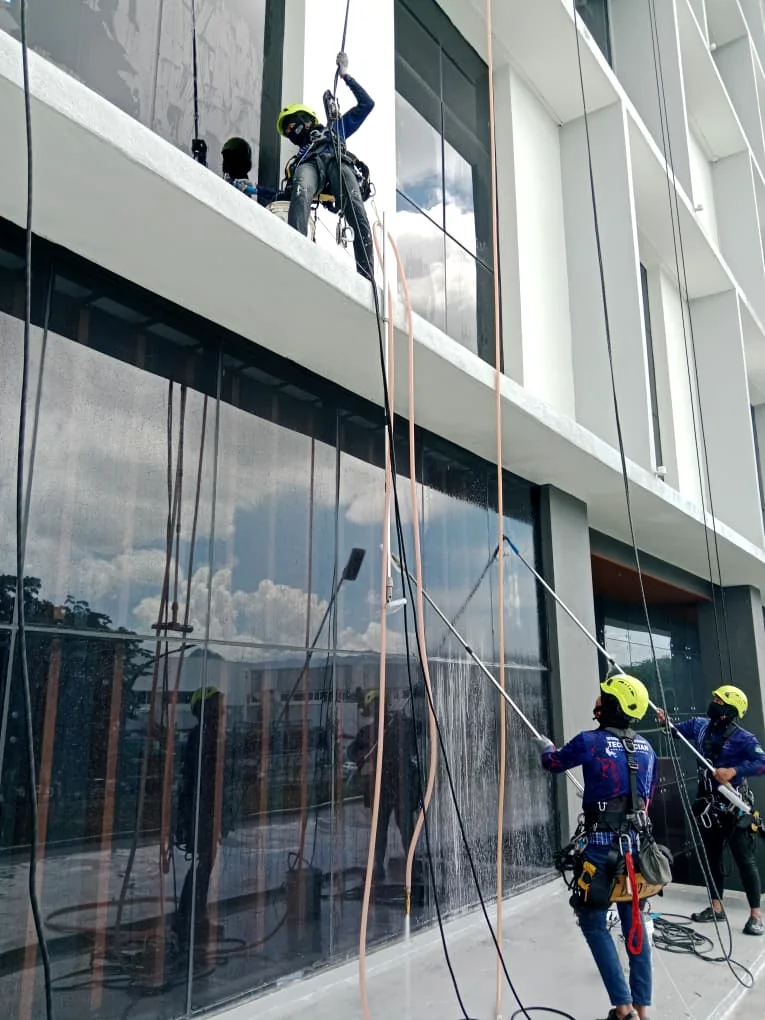 Rope access work around a commercial building signboard